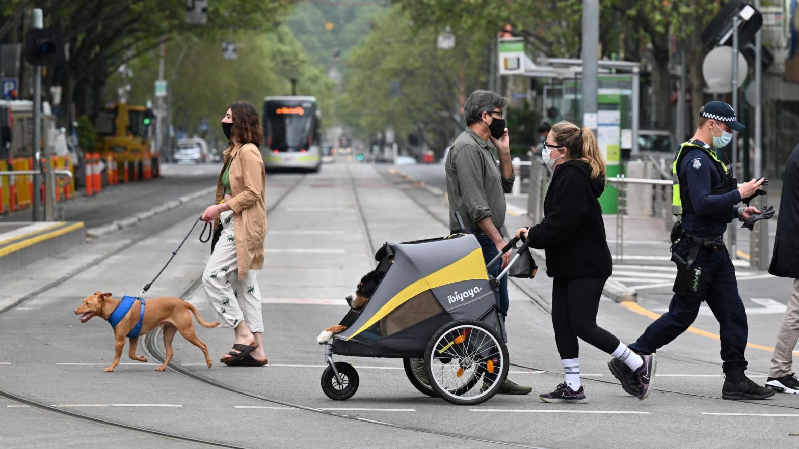 People walk their dogs in Melbourne, Australia on September 30, 2021. (Photo: William West/AFP, Getty Images)
