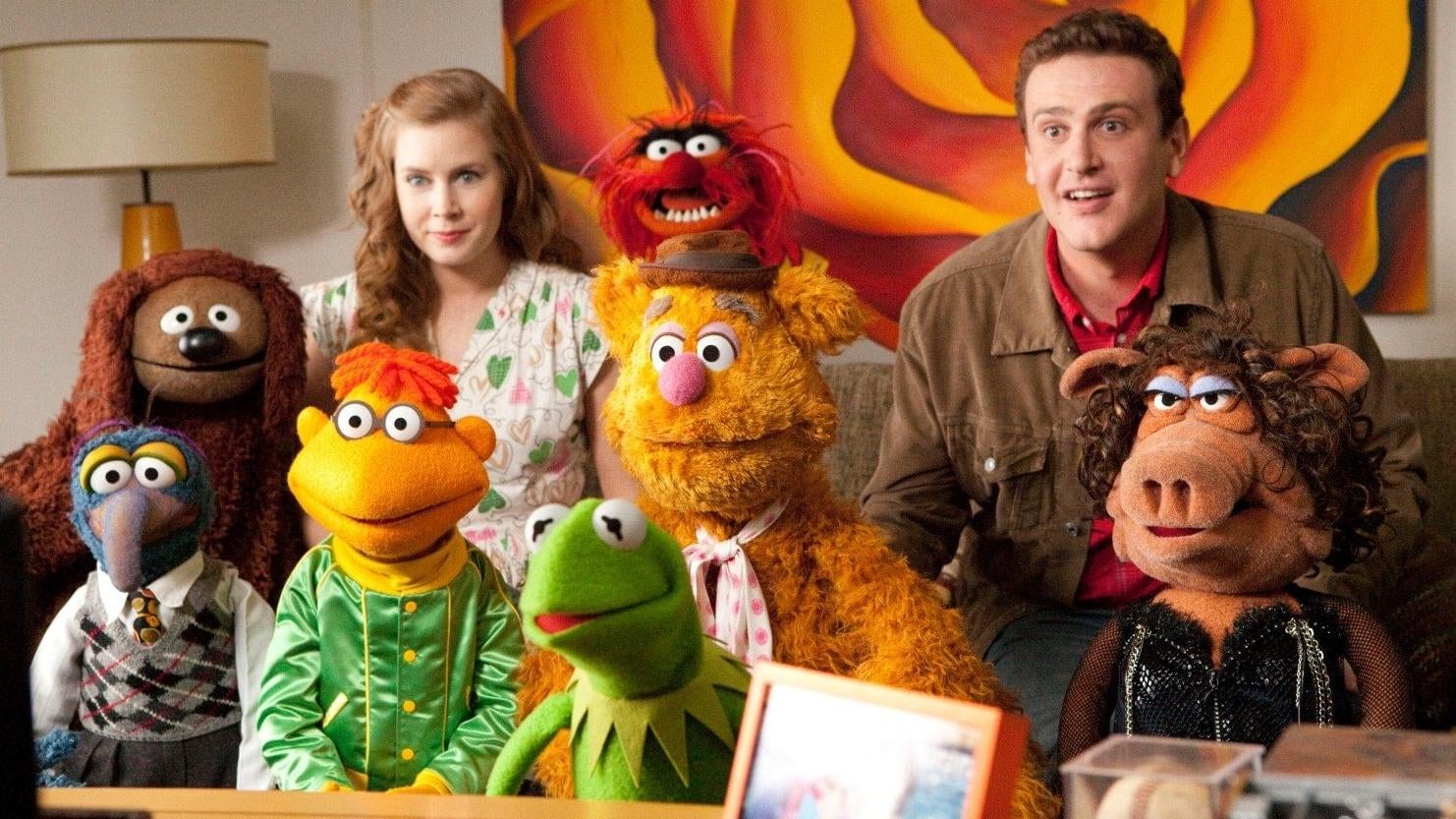 Amy Adams, Jason Segel, and the Muppets in The Muppets. (Image: Disney)