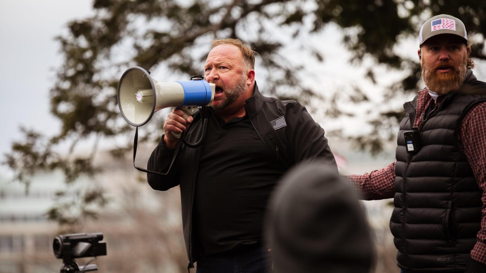 Alex Jones speaking outside the Capitol after Donald Trump supporters assaulted police and broke into the building en masse on Jan. 6, 2021. (Photo: Jon Cherry, Getty Images)