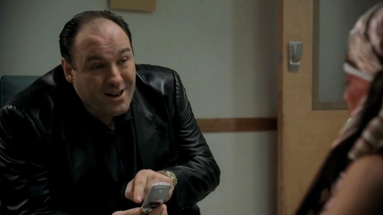 Tony Soprano, played by James Gandolfini, pointing at a Motorola cell phone. (Screenshot: HBO / The Sopranos)