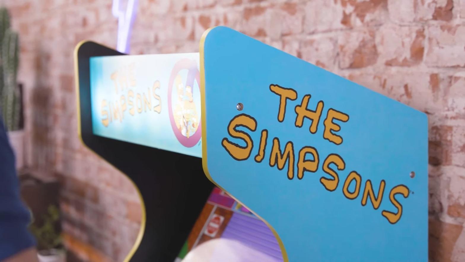 The top of a blue arcade cabinet with the logo for The Simpsons