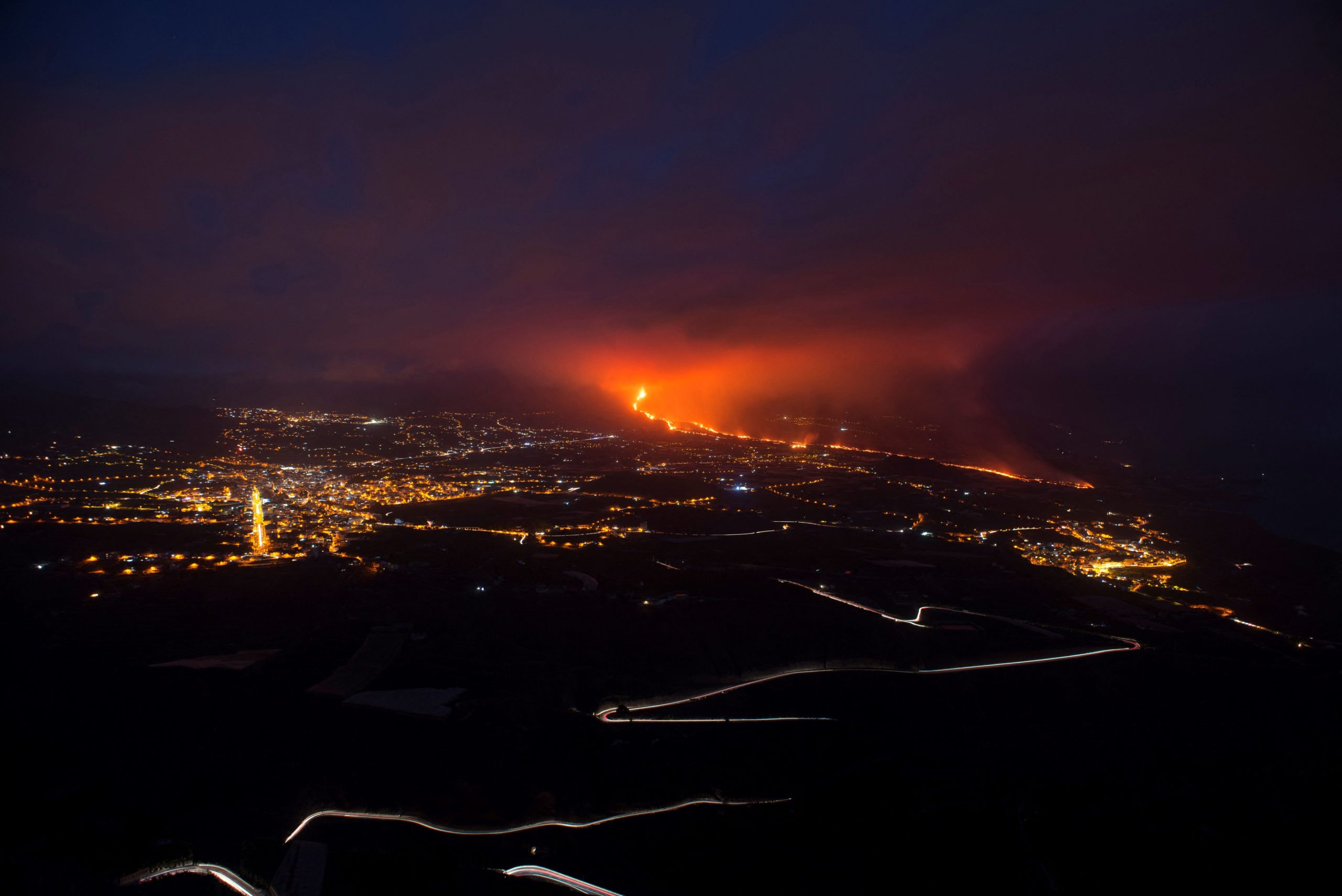  The Cumbre Vieja volcano, pictured from Tijarafe, spews lava, ash, and smoke, on the Canary Island of La Palma, at night on October 10, 2021. (Photo: Jorge Guerrero/AFP, Getty Images)
