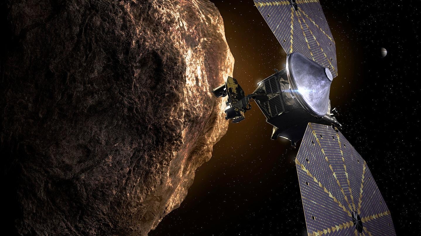 Artist's depiction of Lucy zipping past a Trojan asteroid.  (Image: Southwest Research Institute)