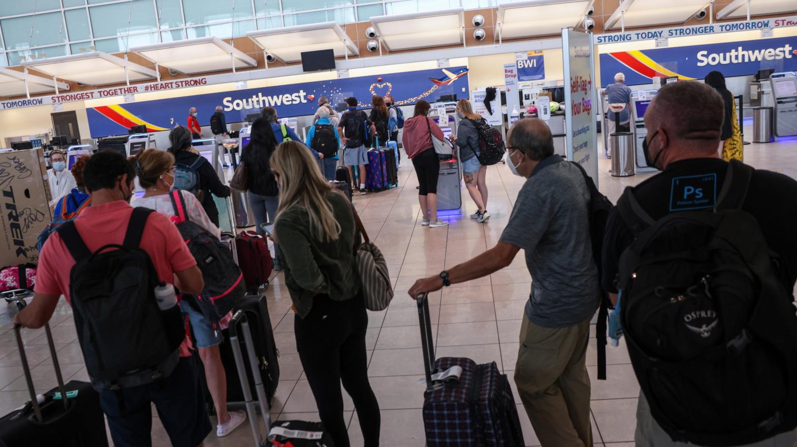 Southwest Airlines travellers wait at the check-in counter at Baltimore Washington International Thurgood Marshall Airport on Oct. 11, 2021, among widespread cancellations and delays that are definitively not about Joe Biden's vaccine policies. (Photo: Kevin Dietsch, Getty Images)