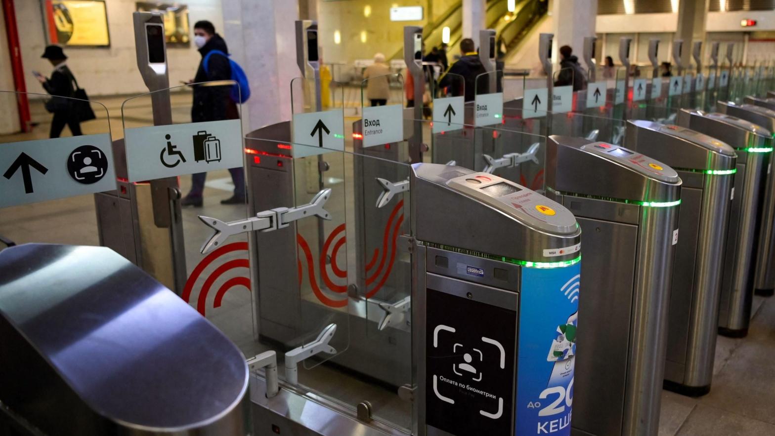 A sign sits on a ticket gate equipped with a facial recognition fare payment system - Face Pay - at Turgenevskaya metro station in Moscow on September 23, 2021. (Photo: Natalia Kolesnikova / AFP, Getty Images)