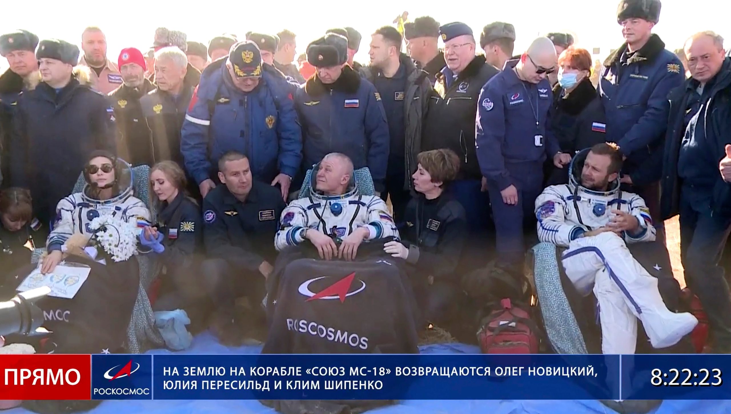 Russian space agency cosmonaut Oleg Novitskiy, centre, actress Yulia Peresild, left, and film director Klim Shipenko sit in chairs shortly after the landing of the Russian Soyuz MS-18 space capsule. (Image: Roscosmos Space Agency, AP)