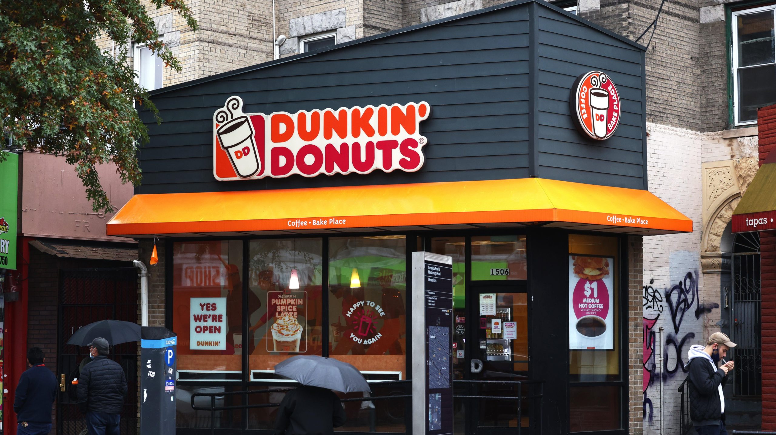 People walk past a Dunkin' store on October 26, 2020 in New York City. (Photo: Michael M. Santiago, Getty Images)