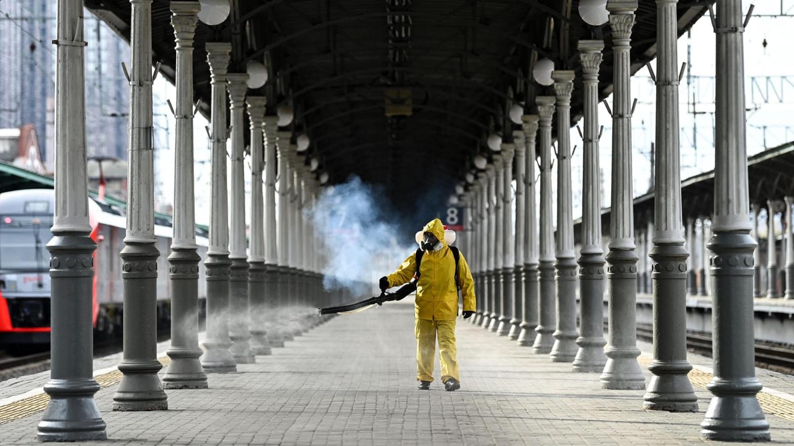 A serviceman of Russia's Emergencies Ministry wearing protective gear disinfects Moscow's Belorussky railway station on October 20, 2021. (Photo: Kirill Kudryavtsev/AFP, Getty Images)