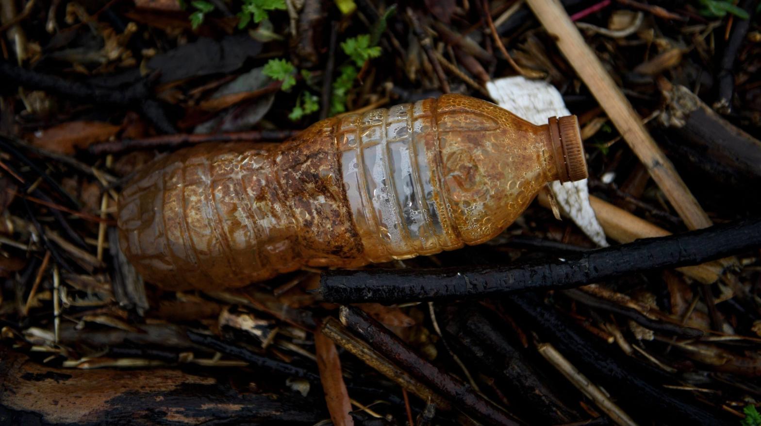 A plastic water bottle is seen washed up on the banks of the Anacostia River on March 21, 2019 in Washington, DC. (Photo: Brendan Smialowski / AFP, Getty Images)