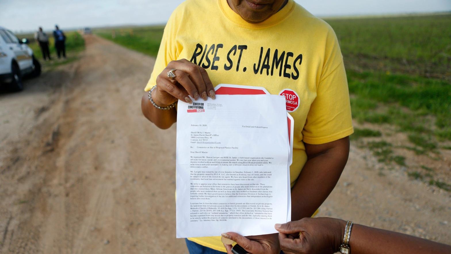 Sharon Lavigne, a member of RISE St. James, holds a letter addressed to the St. James Parish Sheriff, explaining their legal right to access to a burial site on Formosa property. (Photo: Gerald Herbert, AP)