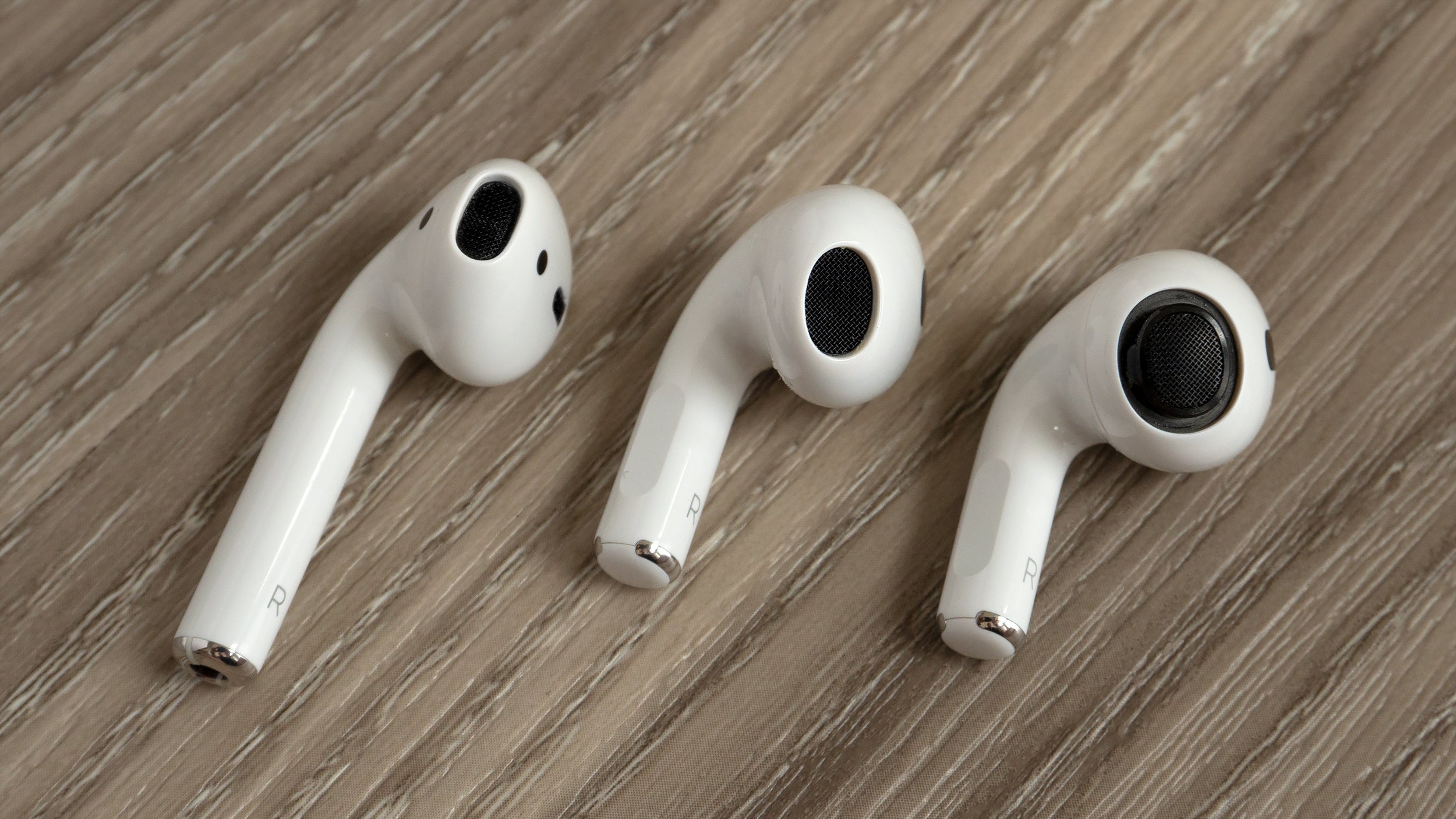 The AirPods 2nd Generation (left) compared to the new AirPods 3rd Generation (centre) and the AirPods Pro with the silicone tip removed (right). (Photo: Andrew Liszewski - Gizmodo)
