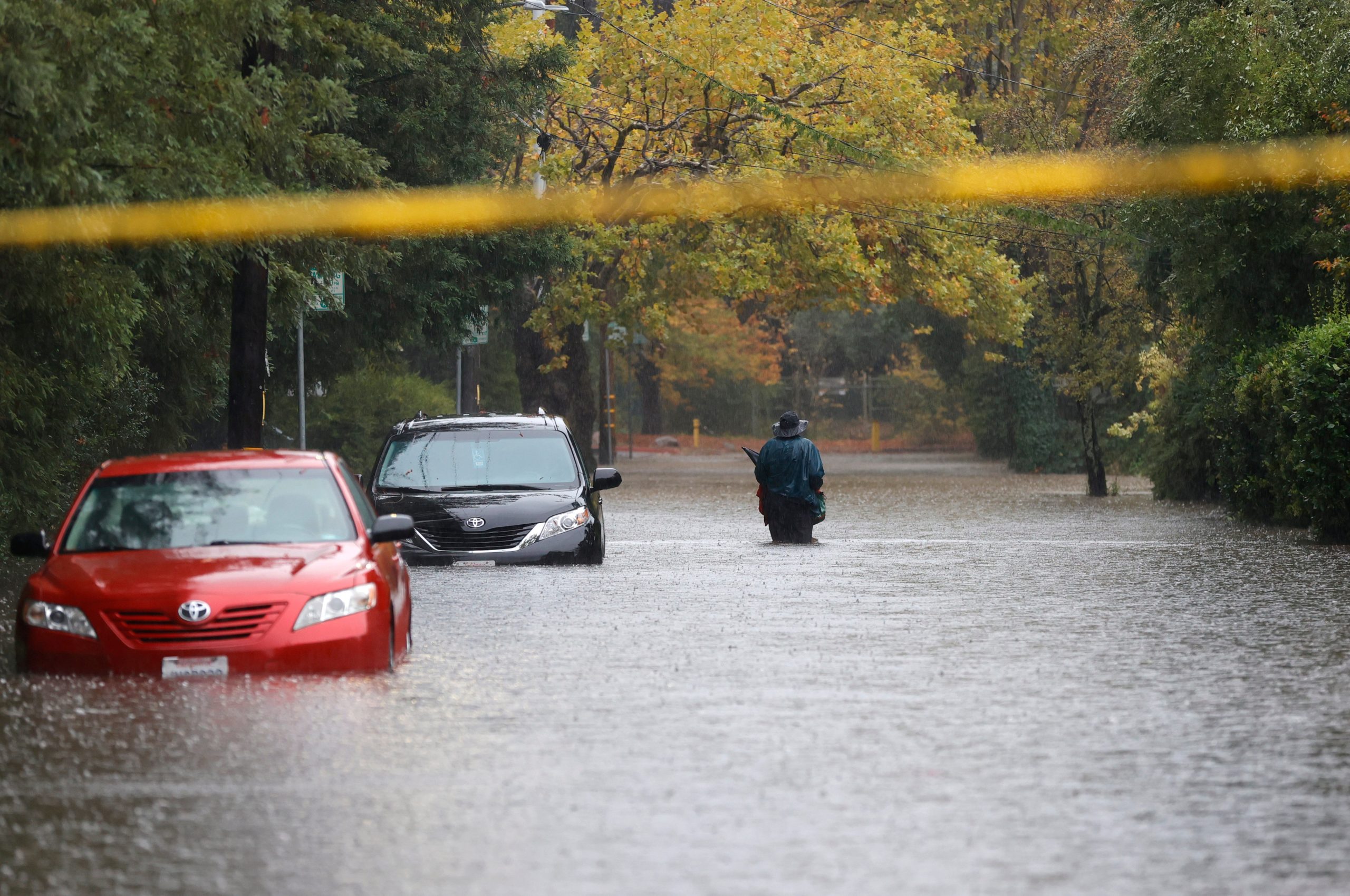 A pedestrian walks on a flooded street on October 24, 2021 in Kentfield, California. (Photo: Justin Sullivan, Getty Images)