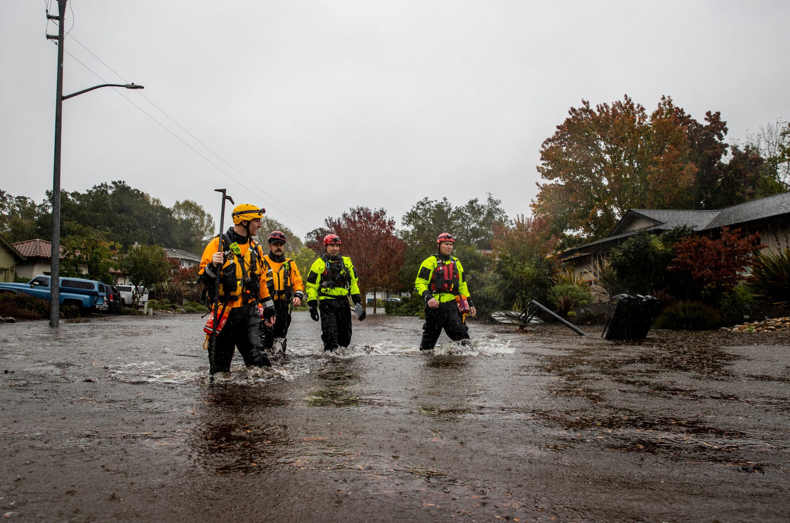 Firefighters check for residents trapped by floodwaters on Brookhaven Drive in Santa Rosa, California. (Photo: Ethan Swope, AP)