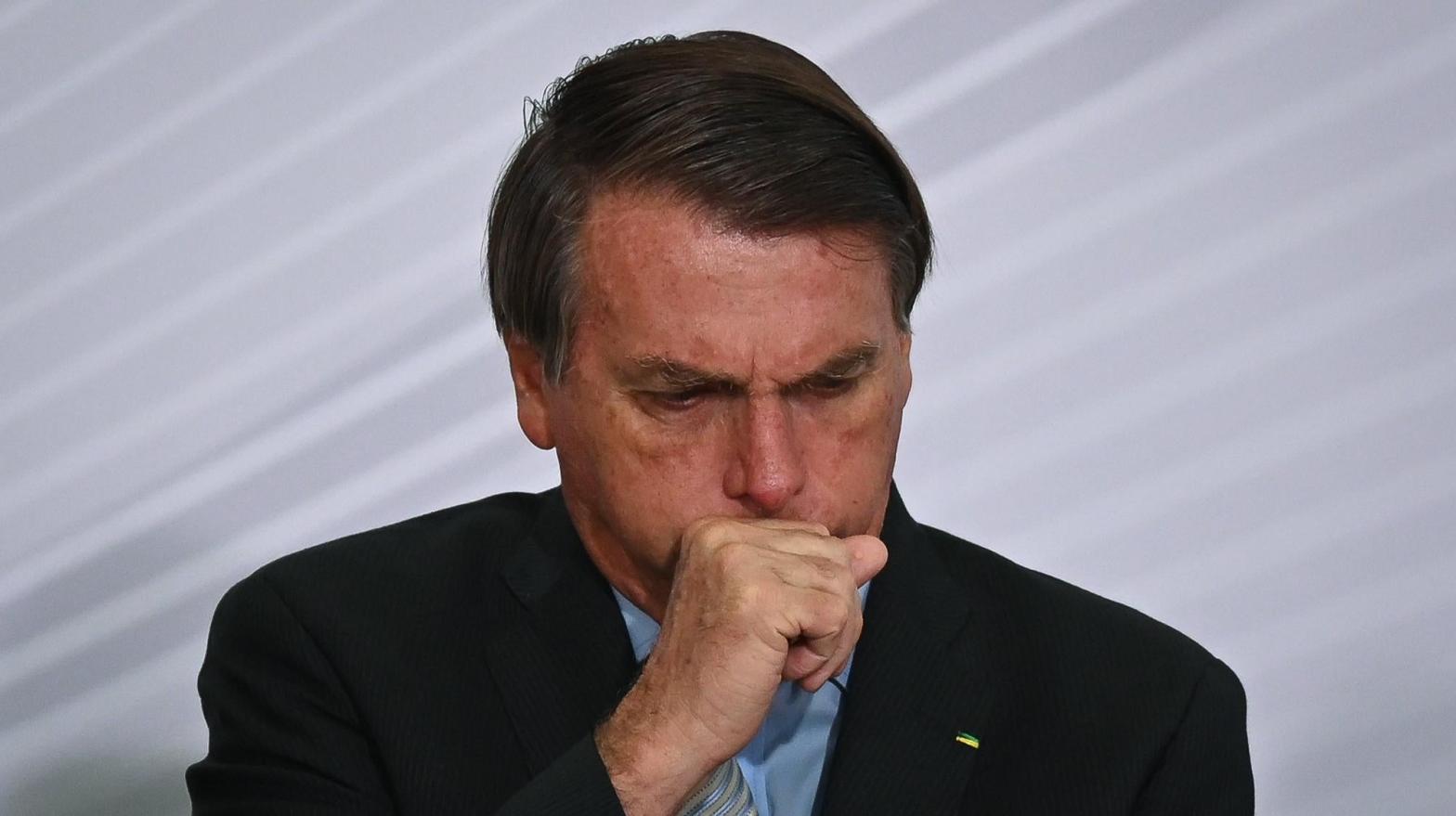 File photo showing President of Brazil Jair Bolsonaro coughing at Planalto Palace on December 9, 2020. (Photo: Andre Borges, Getty Images)