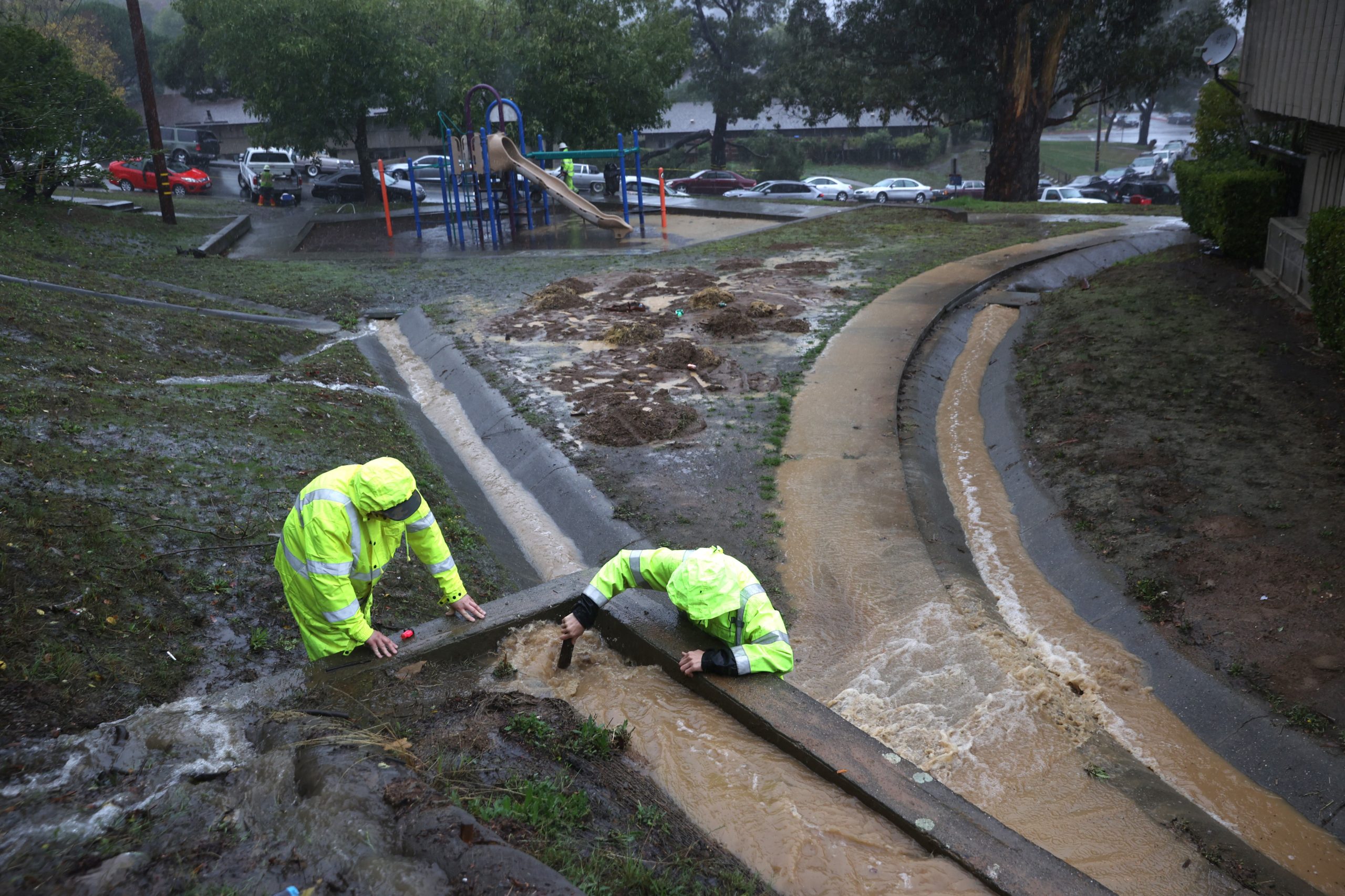 Workers try to divert water into drains as rain pours down on October 24, 2021 in Marin City, California. (Photo: Justin Sullivan, Getty Images)