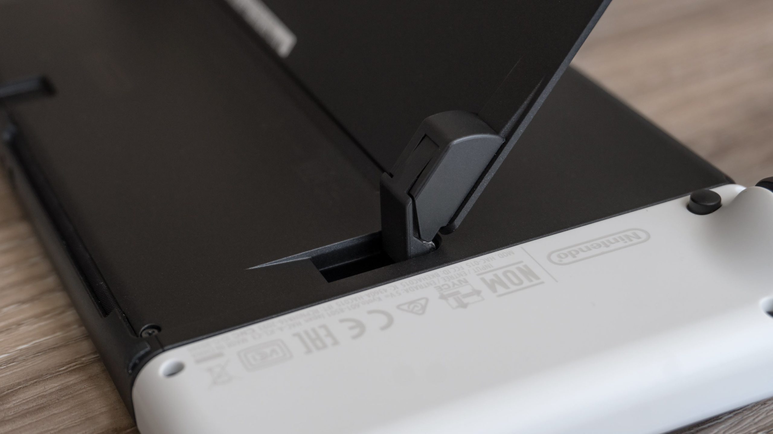 The kickstand on the new Switch OLED is as wide as the console and uses very sturdy adjustable hinges allowing the console to be propped up at any angle. (Photo: Andrew Liszewski - Gizmodo)