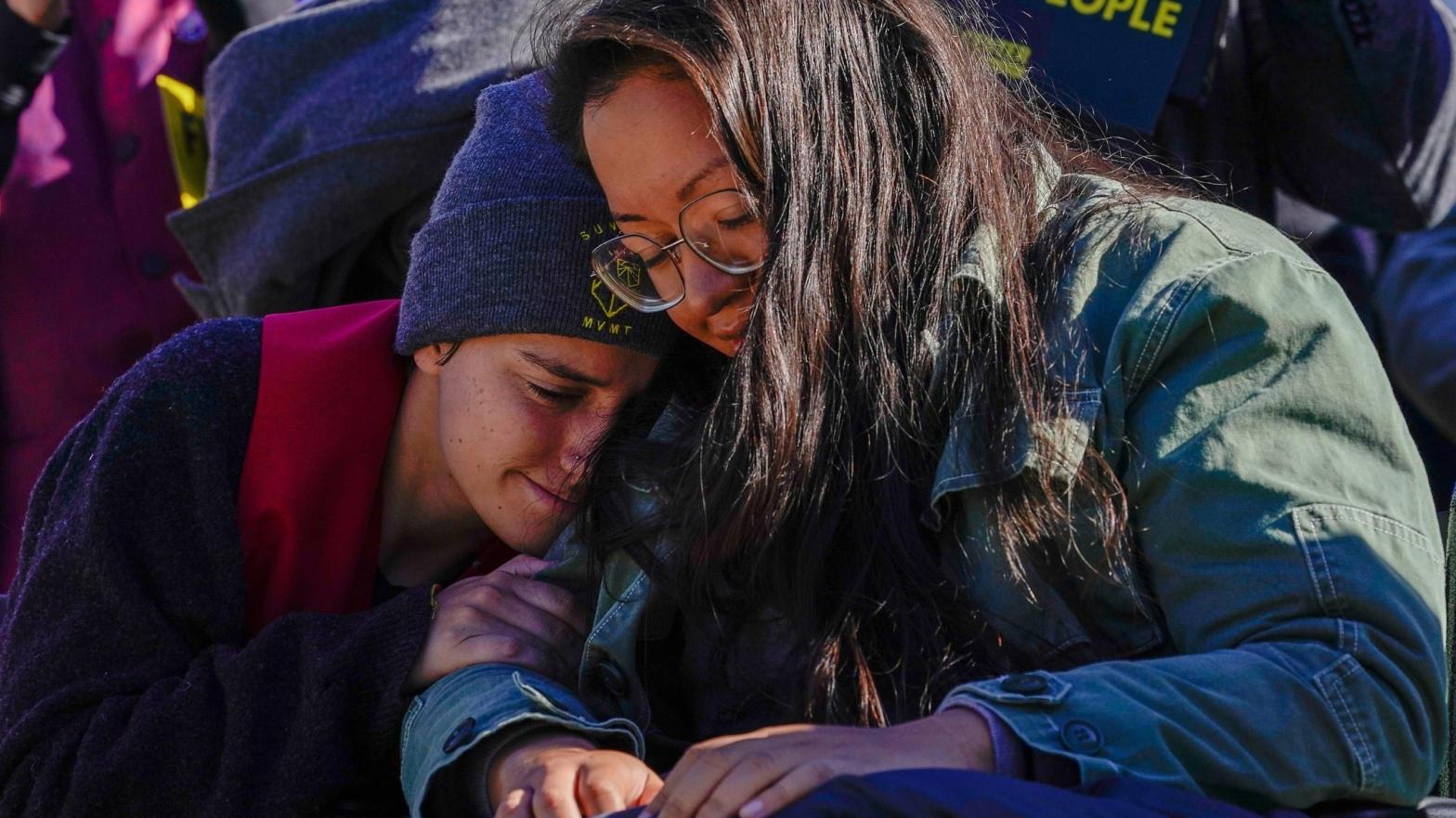 Youth Climate Activists Abby Leedy and Julie Paramo, who are both on a hunger strike, embrace at an action on October 27, 2021 in Washington, DC. (Photo: Jemal Countess/Repairers Of The Breach, Getty Images)