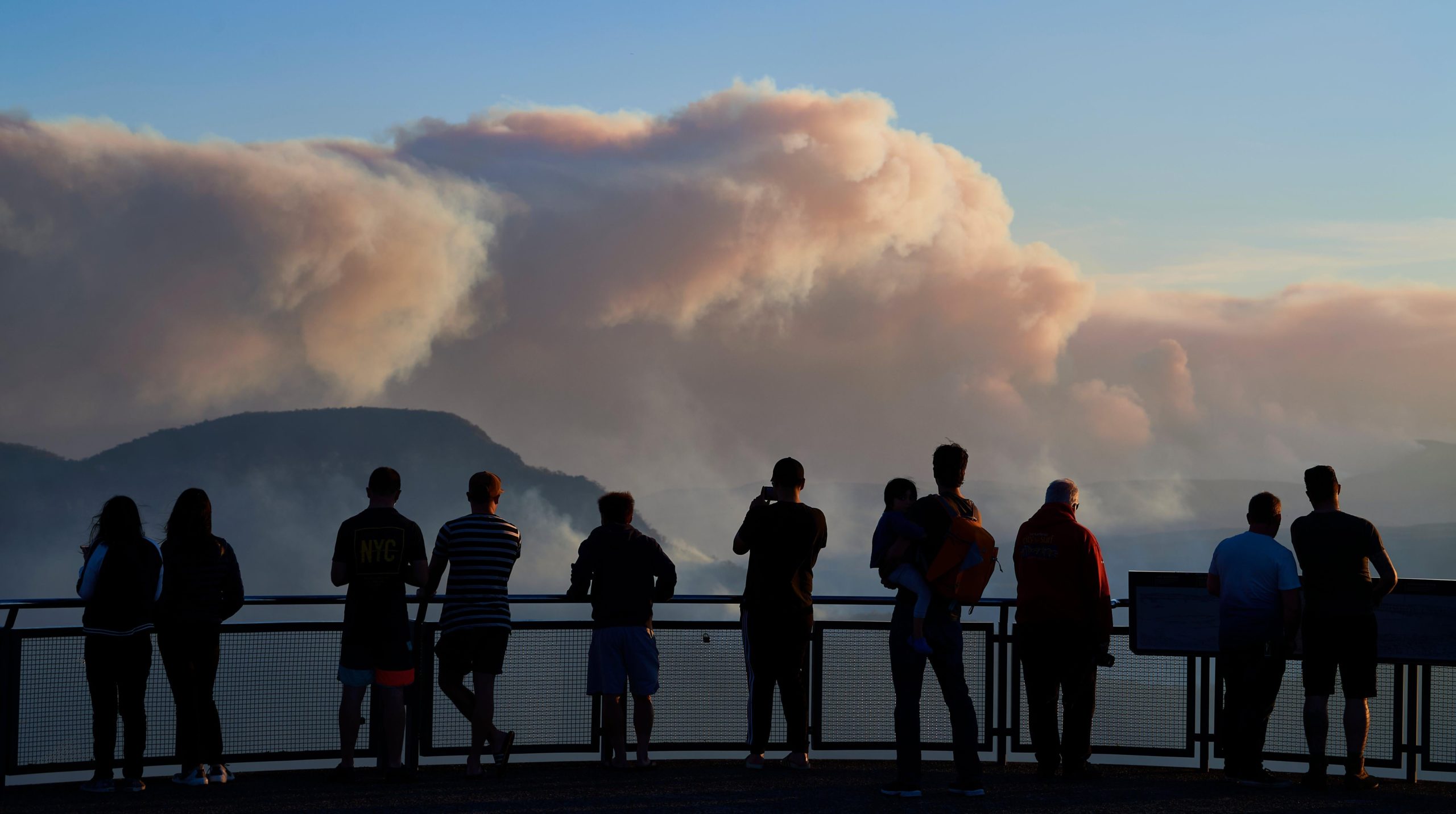 People view smoke from scattered bush fires on a lookout platform in the Blue Mountains. (Photo: Brett Hemmings, Getty Images)