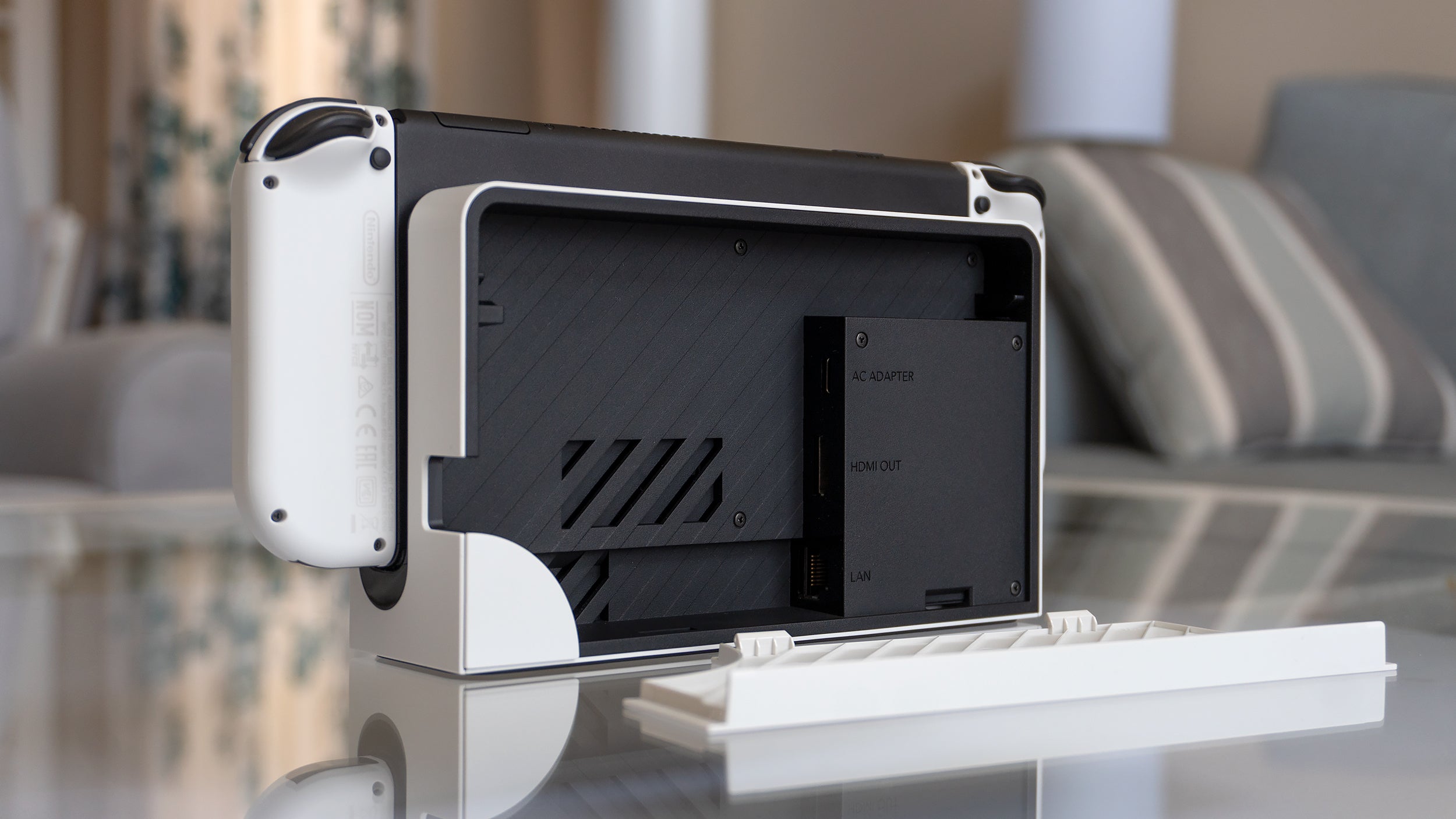 The back panel can be completely removed on the Switch OLED's dock, providing easier access to all the ports, including an added port for a network cable. (Photo: Andrew Liszewski - Gizmodo)