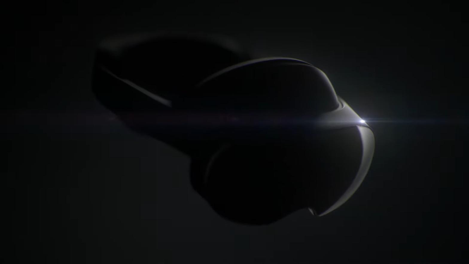 A black headset in front of a black background with some light shining on it from the right side