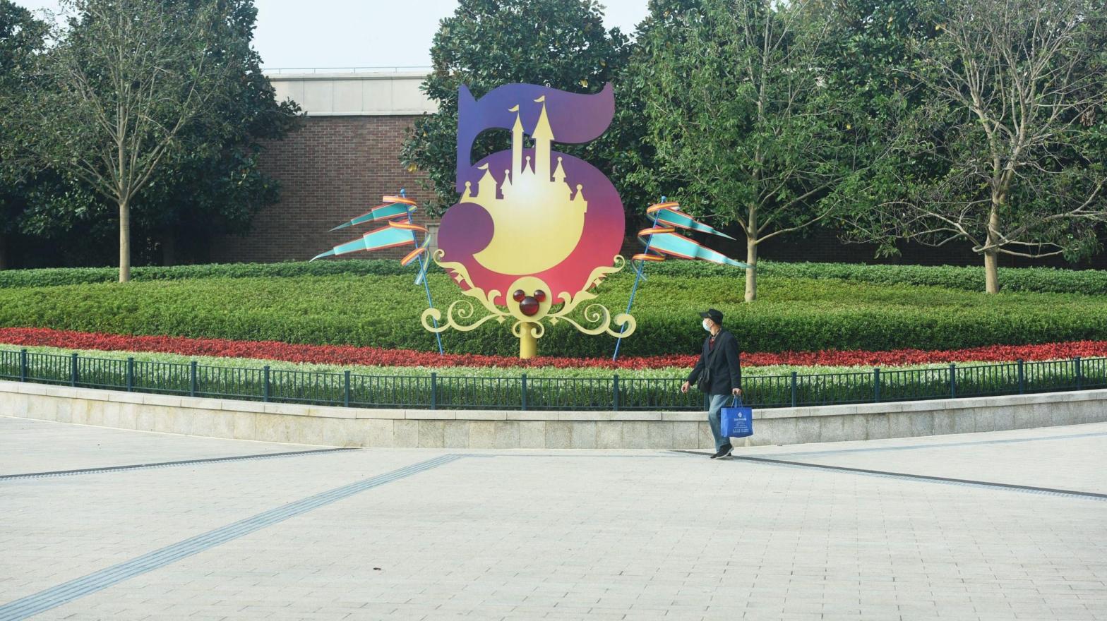 A lone person is seen walking outside Shanghai Disneyland on November 1, 2021. (Photo: STR/AFP, Getty Images)