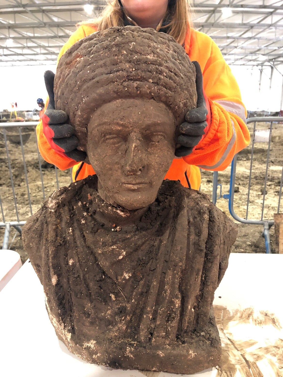 A Roman bust and torso, still caked in dirt.  (Image: HS2)