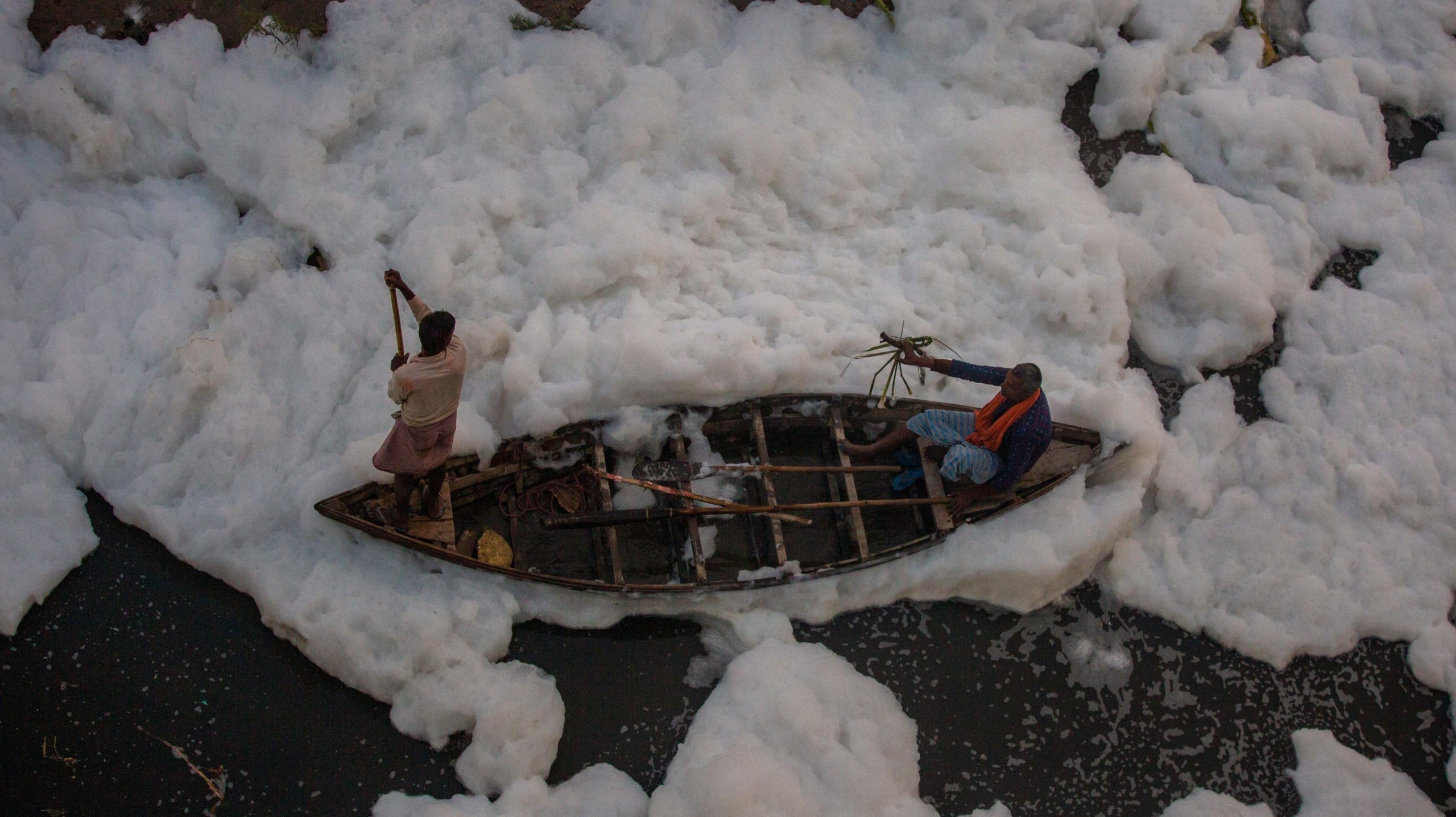 A man rows a boat in Yamuna River. (Photo: Altaf Qadri, AP)