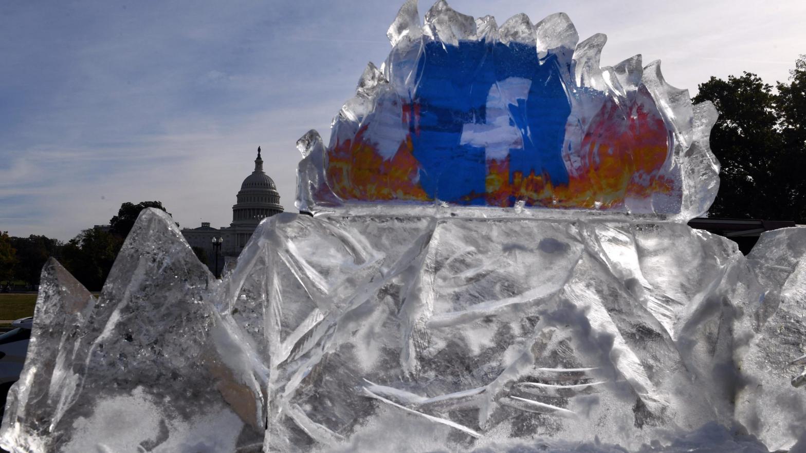 The Facebook logo contained within a 2,268 kg ice sculpture erected by climate activists protesting the company's handling of climate change denialism in front of the U.S. Capitol on Nov. 4, 2021. (Photo: Olivier Douliery / AFP, Getty Images)
