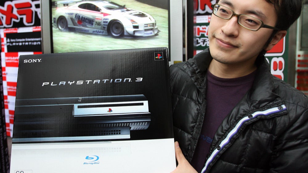 A customer holds a 60GB PlayStation 3 at a launch event in Tokyo.  (Photo: YOSHIKAZU TSUNO/AFP, Getty Images)