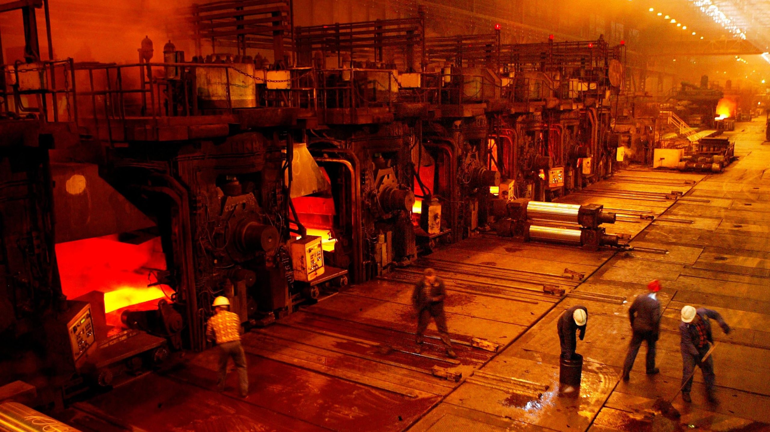 Workers clean the floors next to the hot rolling mill at the Sendzimir steel plant in Poland. (Photo: Sean Gallup, Getty Images)