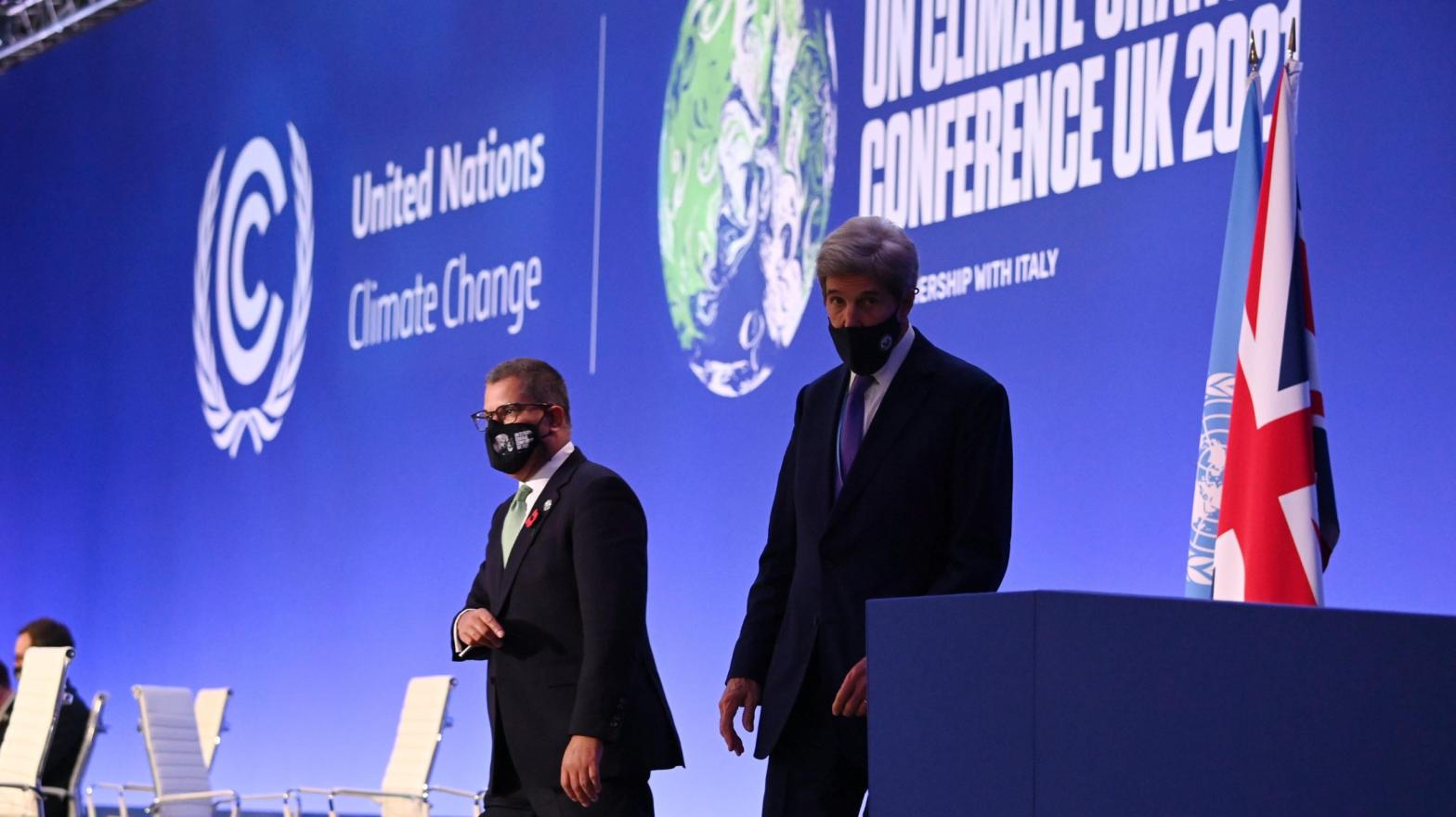 U.S. Special Presidential Envoy for Climate John Kerry (R) with COP26 President Alok Sharma walking off stage. (Photo: Jeff J. Mitchell, Getty Images)