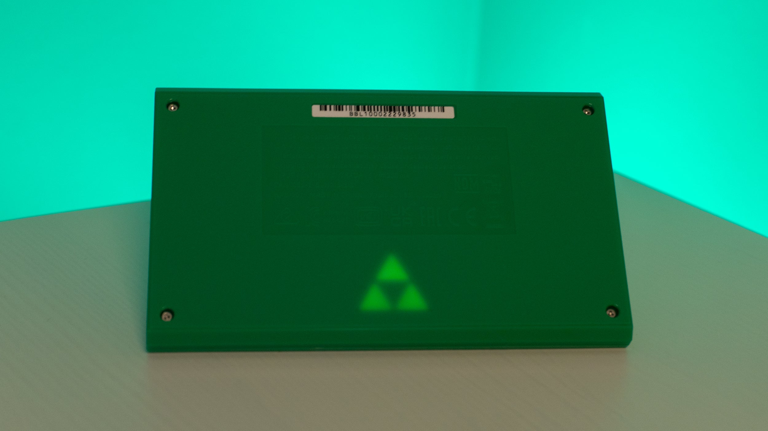 Flip the handheld over and you'll find a subtle glowing Triforce design on the back. (Photo: Andrew Liszewski - Gizmodo)