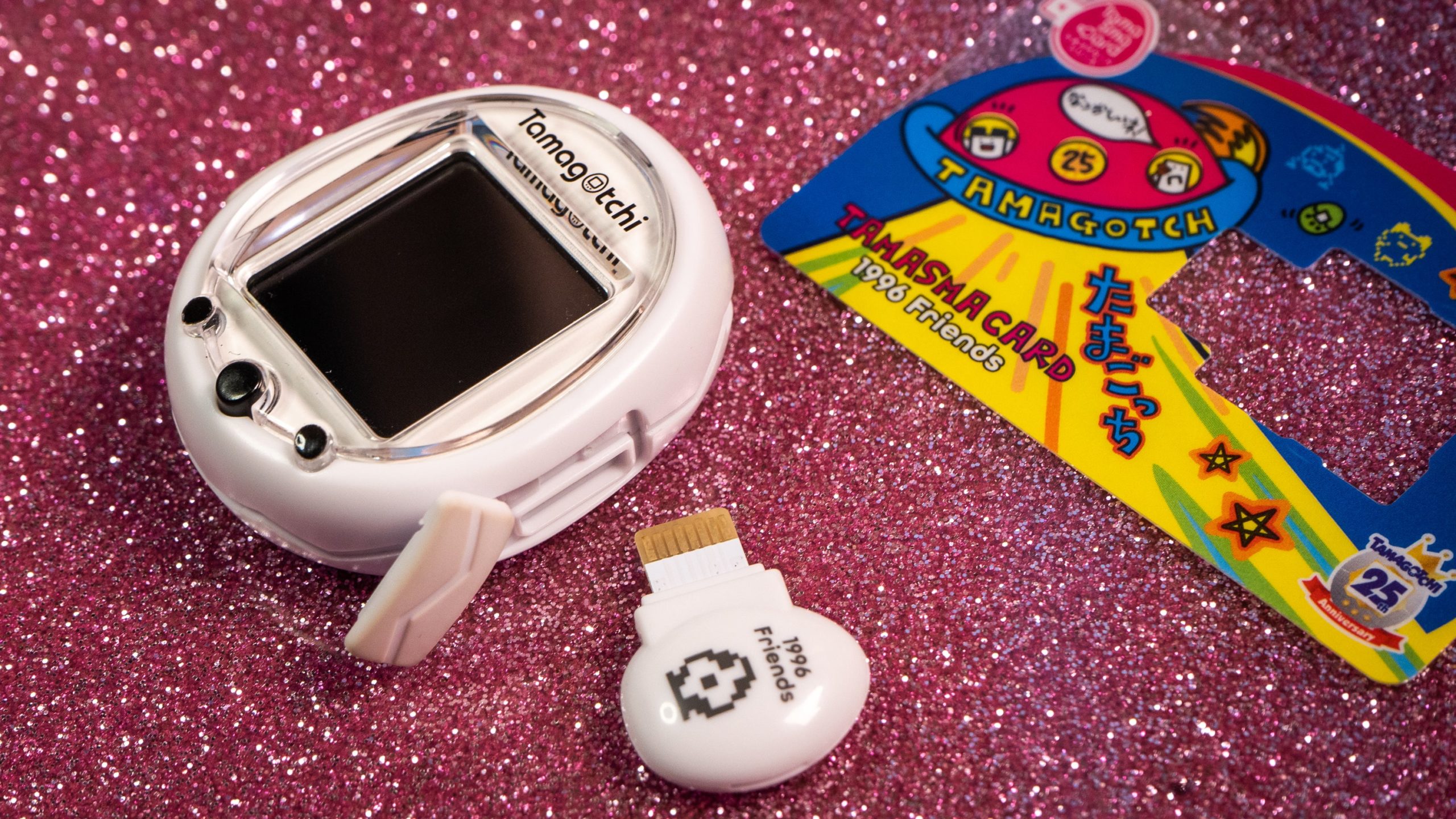 In addition to charging via MicroUSB, the Tamagotchi Smart also takes propriety TamaSma cards, which you'll also have to procure from overseas.  (Photo: Florence Ion / Gizmodo)