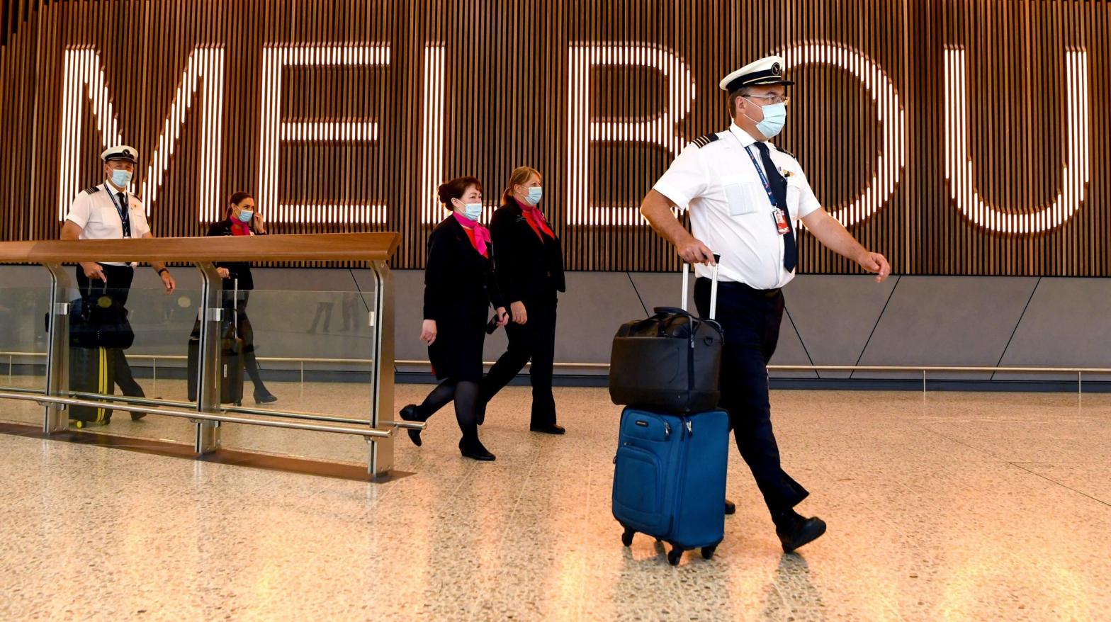 A Qantas flight crew arrive at Melbourne's Tullamarine Airport on November 29, 2021. (Photo: William West / AFP, Getty Images)