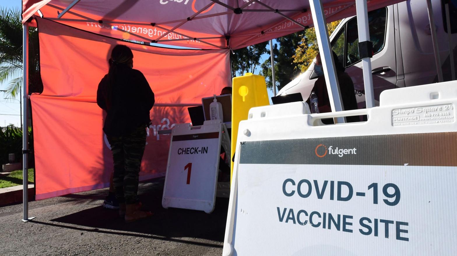 People check-in for their covid-19 vaccine at a pop-up clinic offering vaccines and booster shots in Rosemead, California on November 29, 2021 (Photo: Fredric J. Brown/AFP, Getty Images)