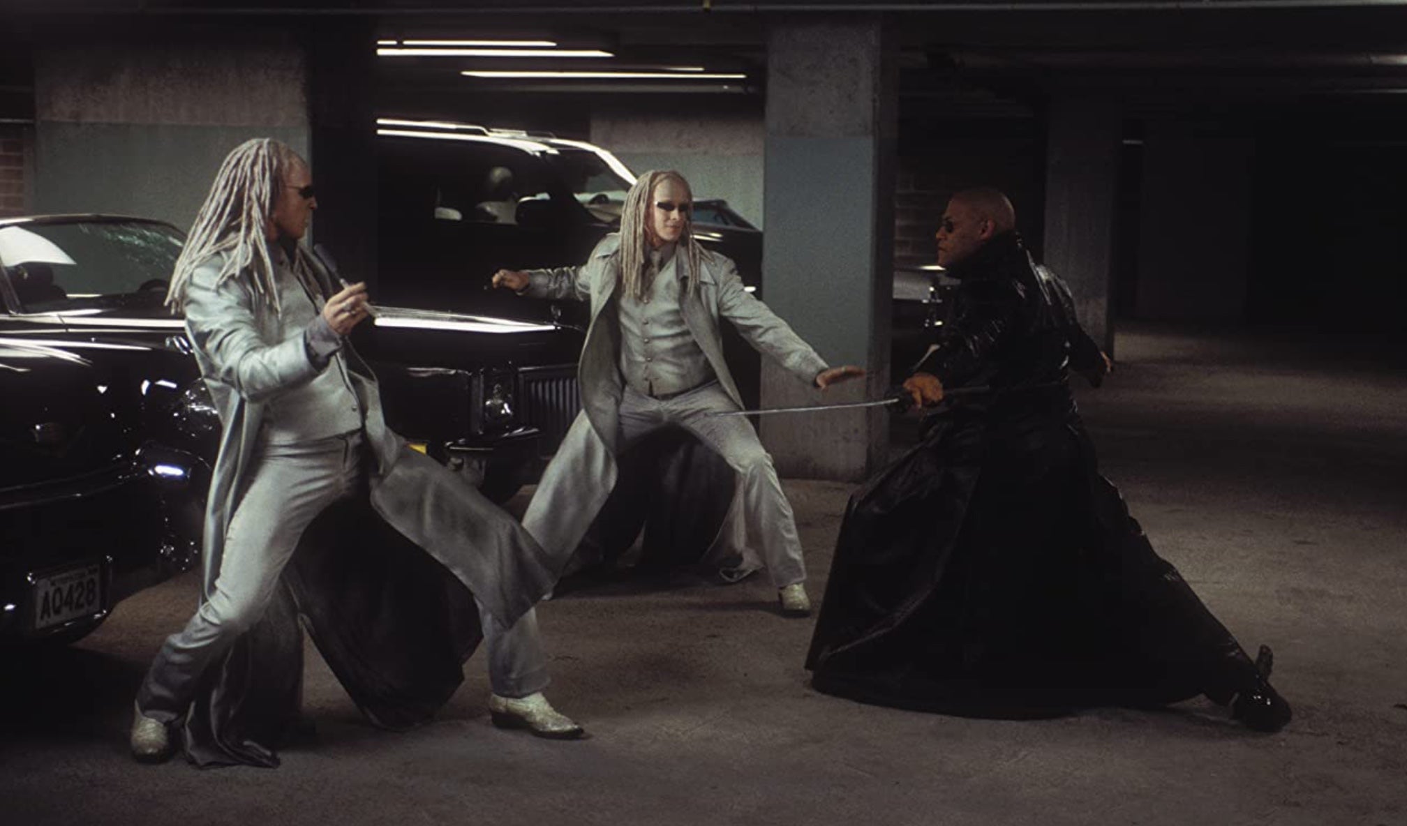 The twins (Adrian Rayment, Neil Rayment) battle Morpheus (Laurence Fishburne) in Reloaded. (Image: Warner Bros.)