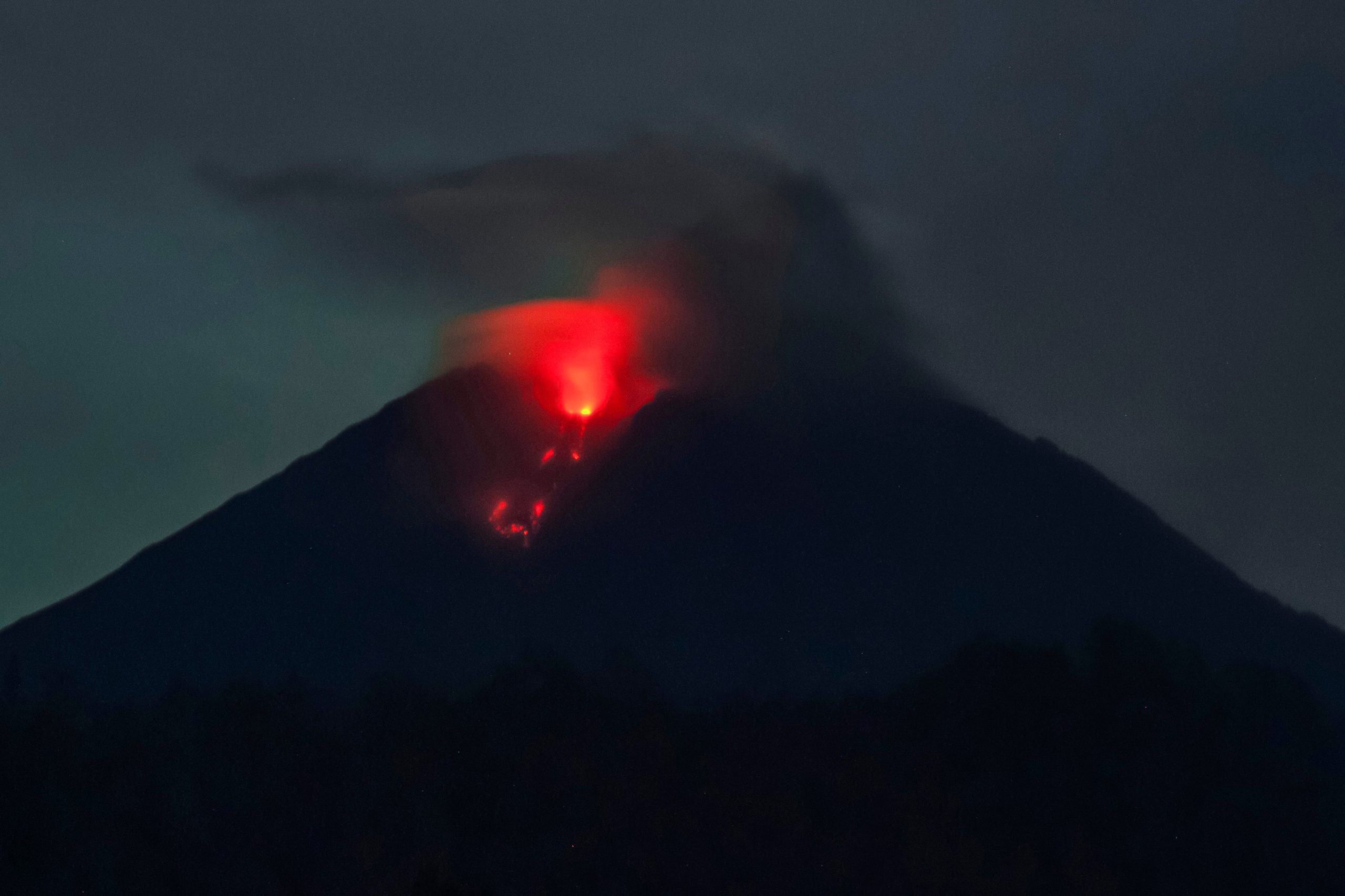 Mount Semeru spews lava as pictured from Sumber Wuluh village in Lumajang on December 6, 2021. (Photo: Juni Kristwanto/AFP, Getty Images)