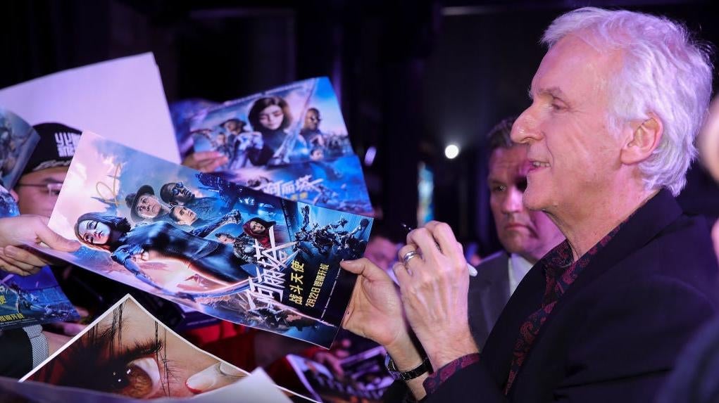 James Cameron signing Alita posters in 2019.  (Photo: Lintao Zhang, Getty Images)