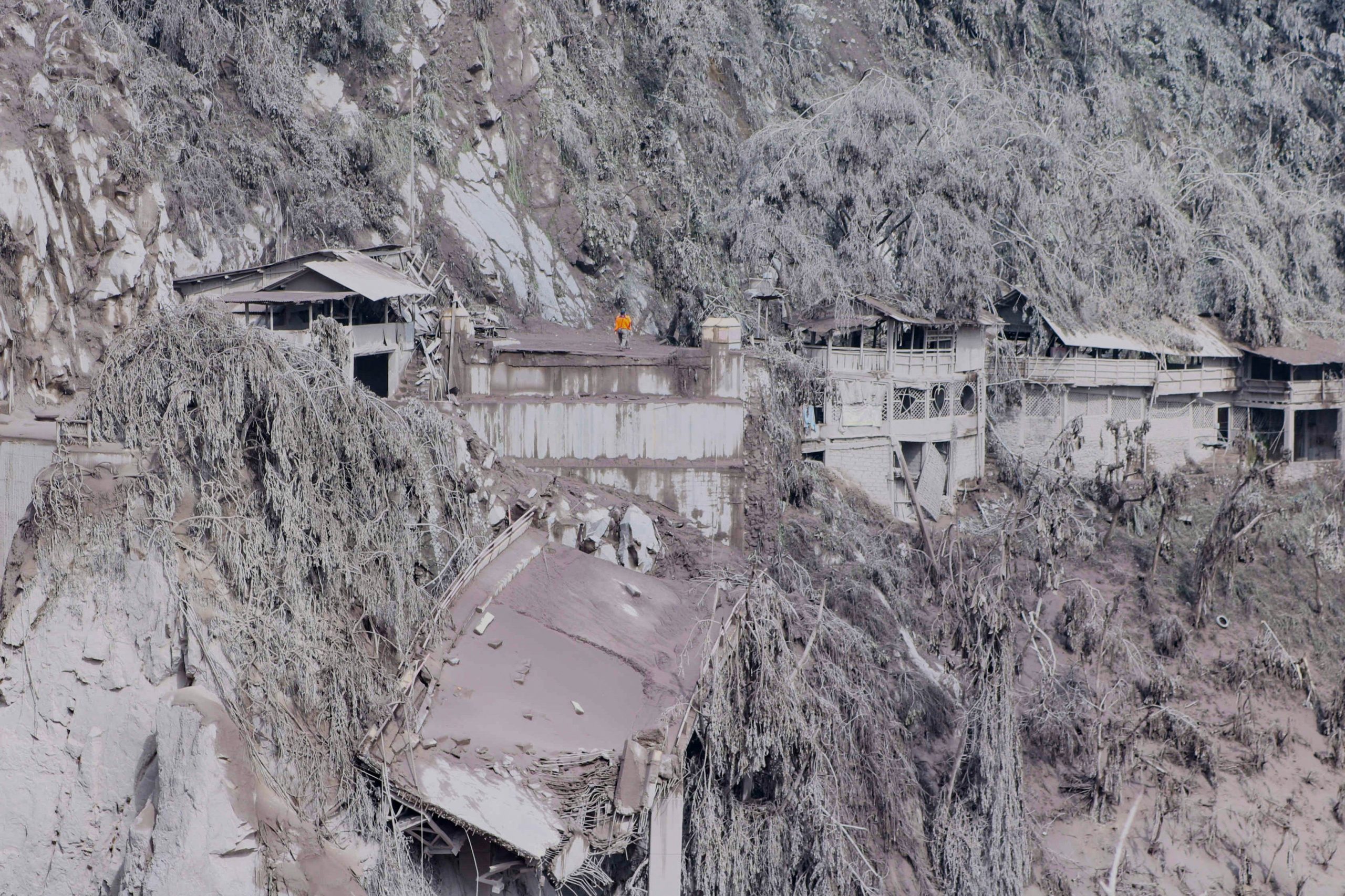Ash covers houses and trees on the slopes of Mount Semeru in Lumajang. (Photo: Aman Rochman/AFP, Getty Images)