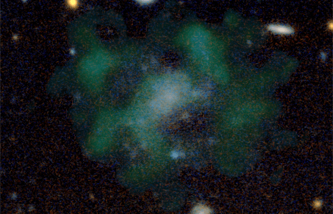 An image of the ultra-diffuse galaxy, with hydrogen gas highlighted in green. (Image: Javier Román & Pavel Mancera Piña)