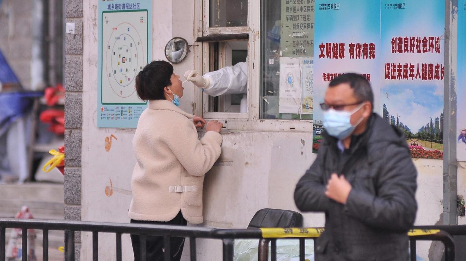 A medical worker takes a swab sample from a resident in Harbin, in China's northern Heilongjiang province on November 3, 2021.  (Photo: STR / AFP, Getty Images)