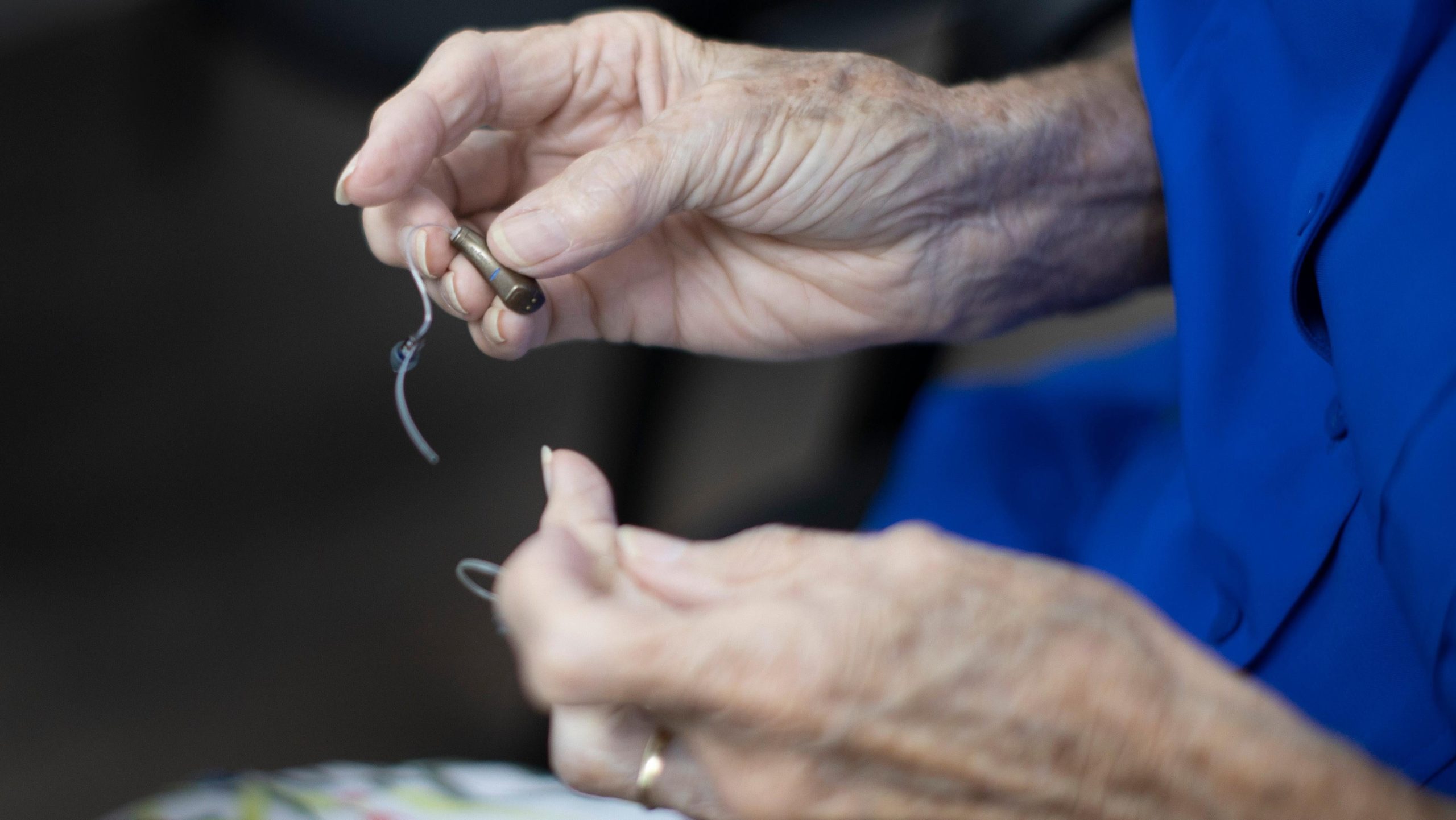 A person holding their hearing aids. (Photo: Joe Raedle, Getty Images)