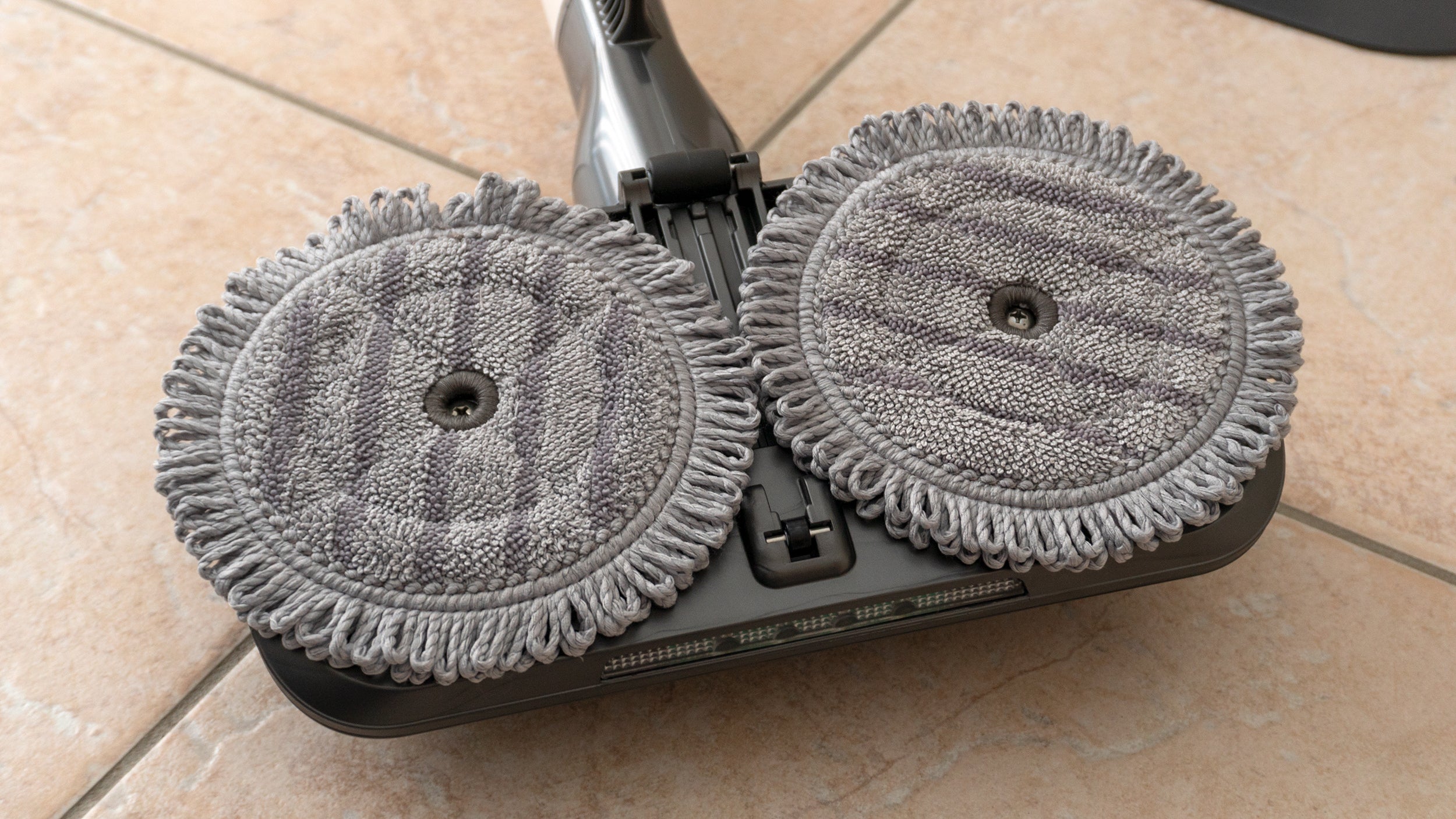 Two spinning pads take the hard work out of mopping floors, but the attachment isn't the most convenient to use, and you can't fill it with soaps or detergents, only water. (Photo: Andrew Liszewski/Gizmodo)