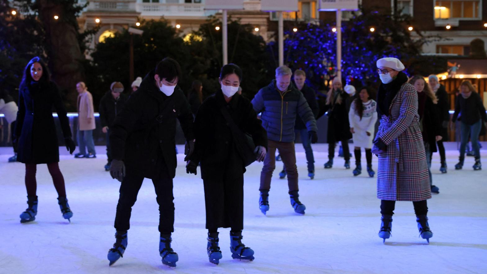 Skaters on the ice rink at the Natural History Museum in central London on December 9, 2021.  (Photo: Hollie Adams / AFP, Getty Images)
