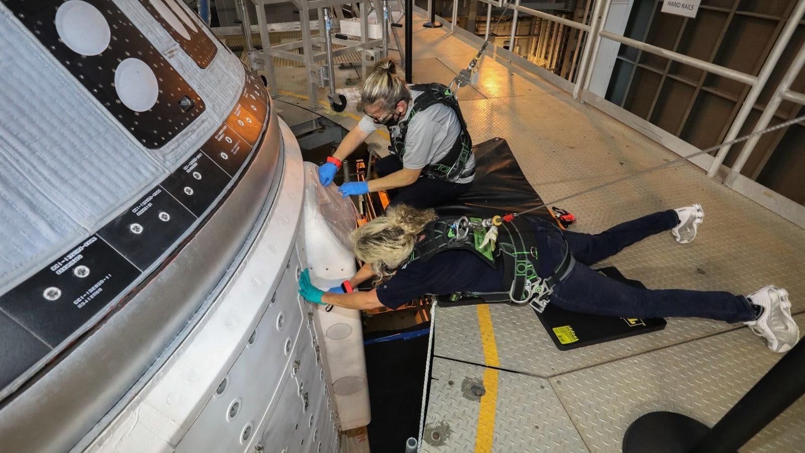 Boeing engineers attending to the faulty Starliner, parked inside the Vertical Integration Facility (VIF) at Space Launch Complex-41. (Photo: Boeing)