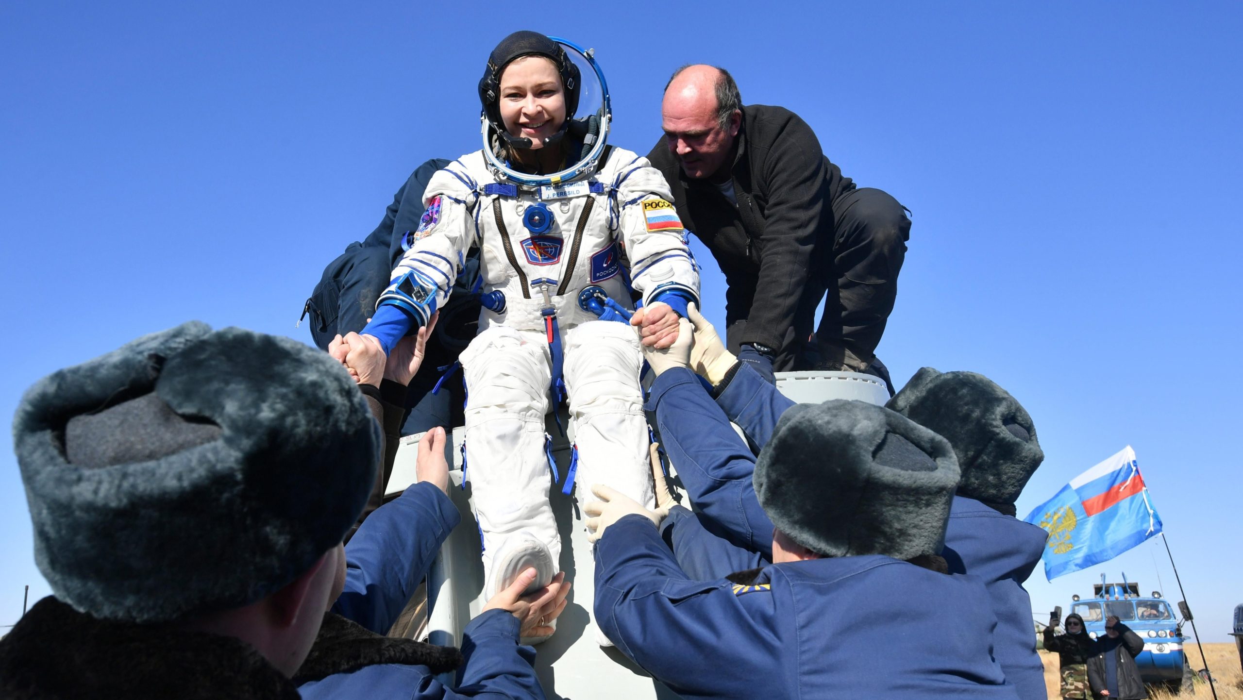 Russian space agency rescue team members help actress Yulia Peresild out from the capsule shortly after the landing of the Russian Soyuz MS-18 space capsule. (Photo: Roscosmos Space Agency, AP)