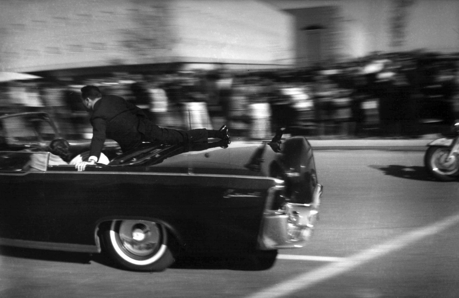 The limousine carrying President John F. Kennedy races toward the hospital seconds after he was shot in Dallas on Nov. 22, 1963. (Photo: Justin Newman, AP)