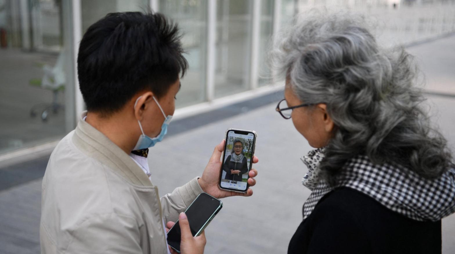 Chinese social media influencer and grandmother Ruan Yaqing, right, and her assistant Xie Xincun, left, reviewing a video intended for her channels on short-form video apps Kuaishou and Douyin in Beijing in April 2021. (Photo: Greg Baker / AFP, Getty Images)