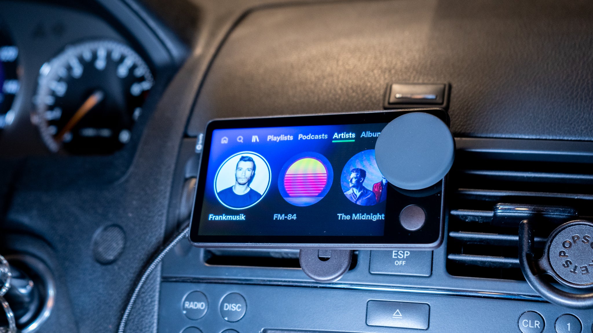Car Thing can take you through your latest playlists, artists, and even your favourite podcasts.  (Photo: Florence Ion / Gizmodo)