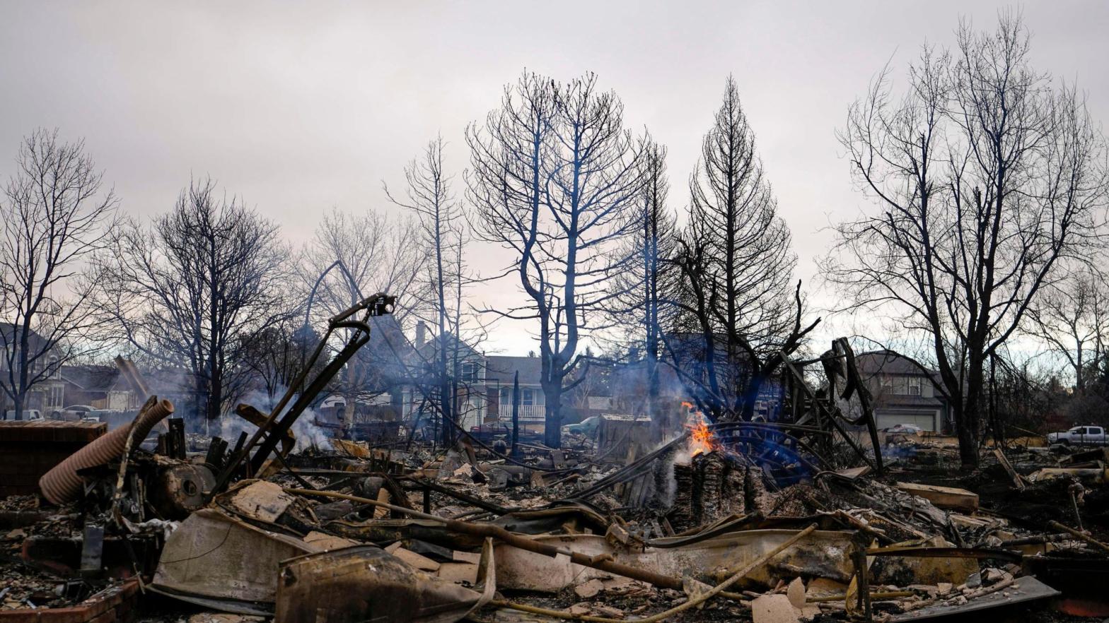 A fire still burns in a home destroyed by the Marshall Wildfire in Louisville, Colo., Friday, Dec. 31, 2021.  (Photo: Jack Dempsey, AP)